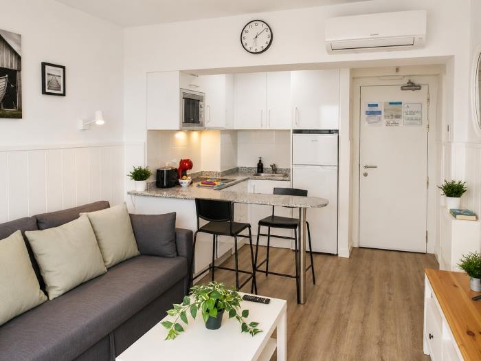 Apartamento moderno y luminoso con cocina equipada, aire acondicionado y salón acogedor.