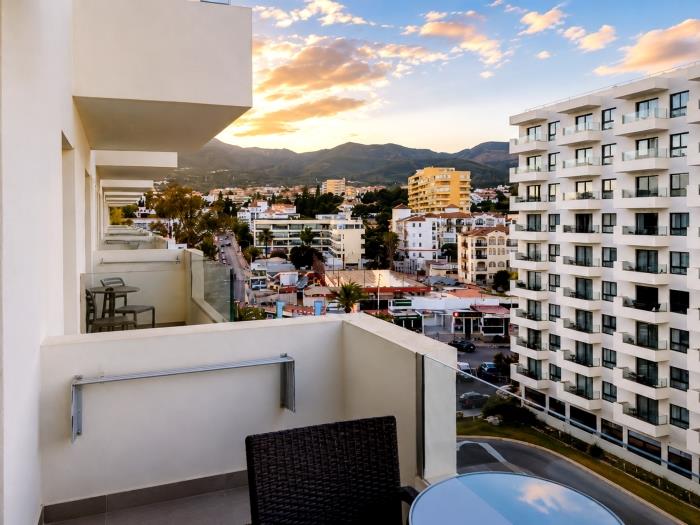 Private terrace with city views, outdoor seating and relaxing atmosphere near the beach.