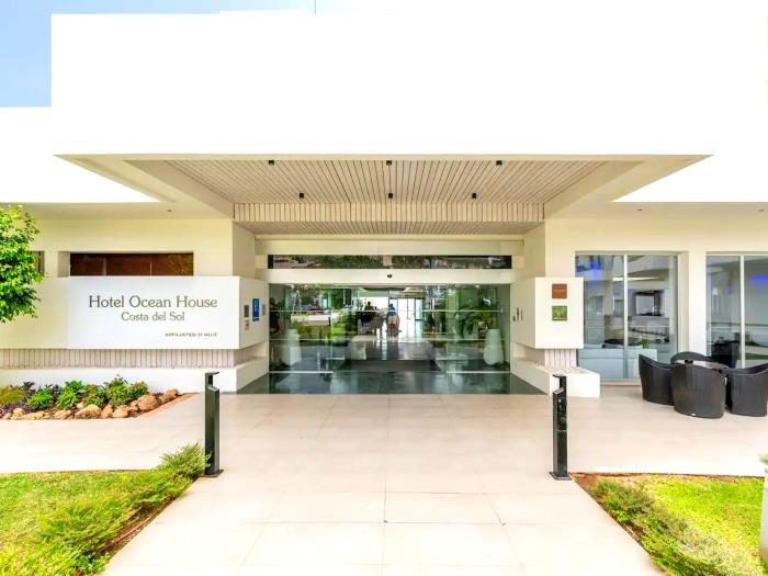 Modern beachfront hotel entrance with elegant design and prime location near the sea.