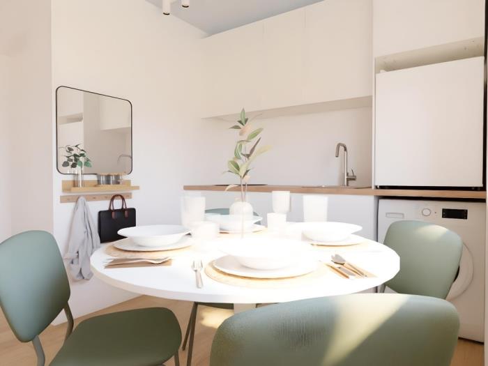 Zona de comedor moderna con cocina equipada, luz natural y diseño contemporáneo elegante.